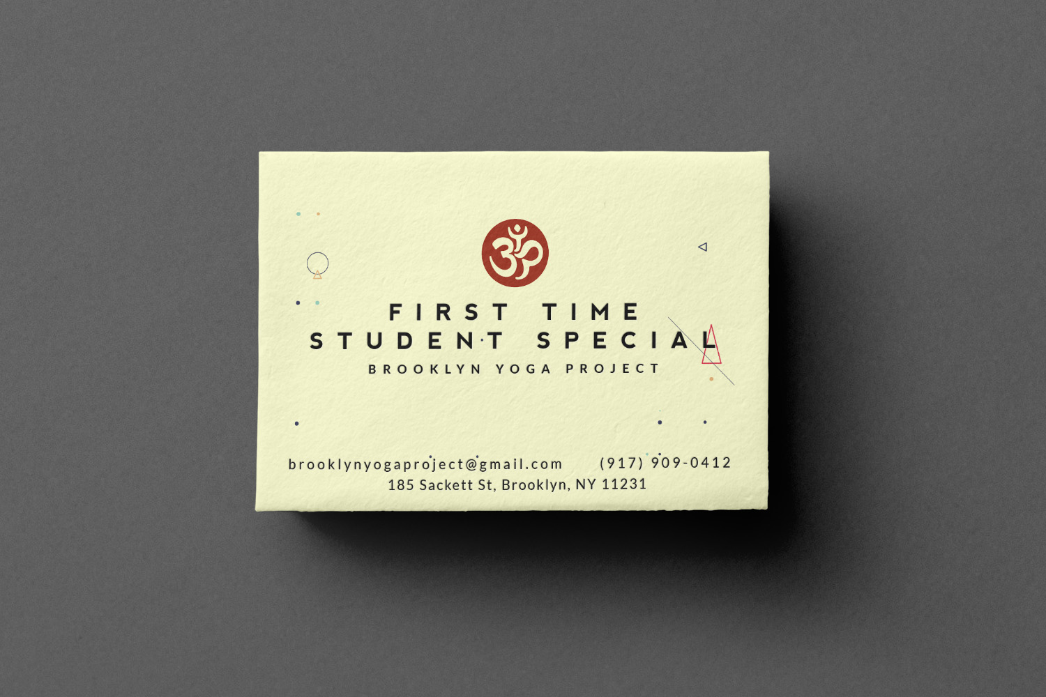 Brooklyn Yoga Project First Time Student Special card, printed with the studio's om mark and Sackett Street address